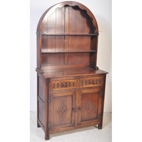 1445 - A Wood Bros Old Charm type Jacobean revival oak dresser. Raised on a plinth base with twin ' linen f... 