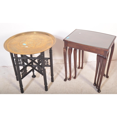 1449 - A vintage mid 20th century mahogany nest of graduating tables raised on cabriole legs with pad feet.... 