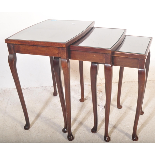 1449 - A vintage mid 20th century mahogany nest of graduating tables raised on cabriole legs with pad feet.... 