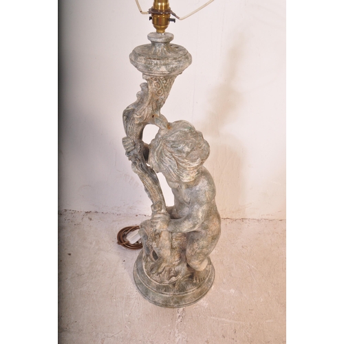 1453 - A 20th century large composite cherub Rococo table lamp with shade. Measures approx. 95cm x 25cm dia... 