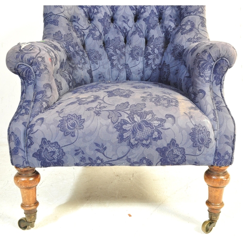 1458 - A Victorian late 19th century upholstered armchair. The chair having a spoon buttoned back over elbo... 