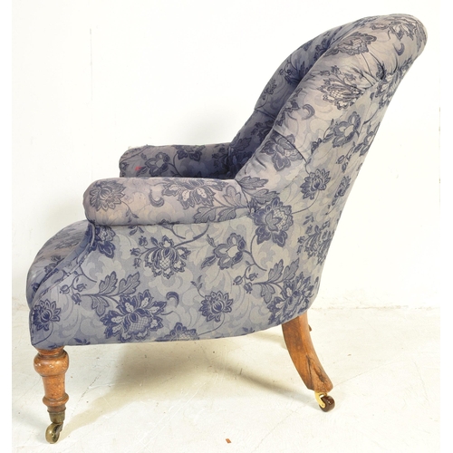 1458 - A Victorian late 19th century upholstered armchair. The chair having a spoon buttoned back over elbo... 