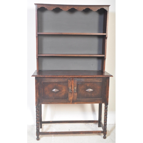 1480 - A vintage 20th century Jacobean Revival gothic style oak welsh dresser having a flared top with apro... 