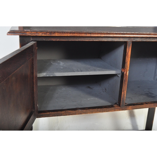 1480 - A vintage 20th century Jacobean Revival gothic style oak welsh dresser having a flared top with apro... 