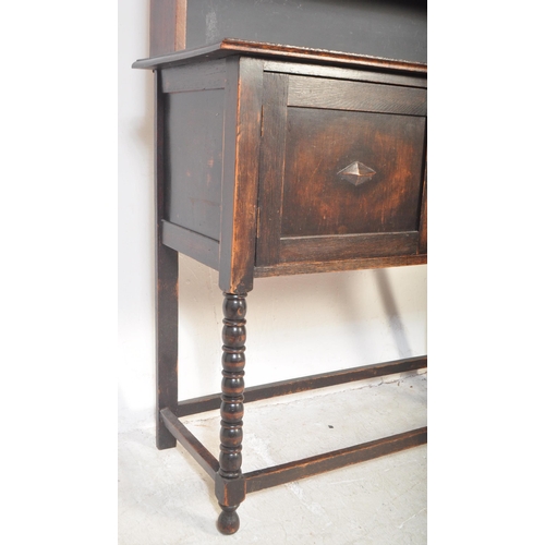 1480 - A vintage 20th century Jacobean Revival gothic style oak welsh dresser having a flared top with apro... 