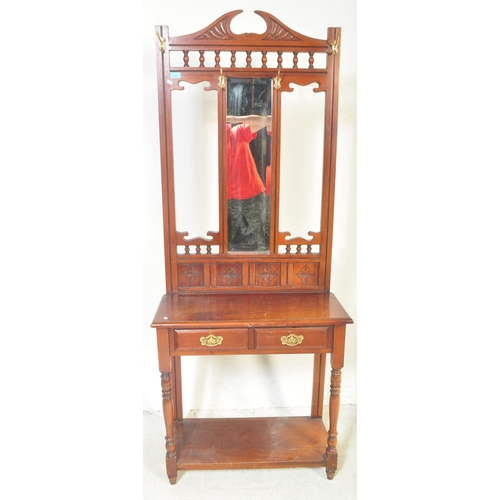 1481 - A Victorian 19th century mahogany hallstand having an arched top pediment over a central mirror on t... 