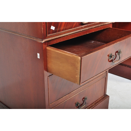 1482 - A 20th century mahogany twin pedestal writing desk. The desk having a red leather skiver to top over... 