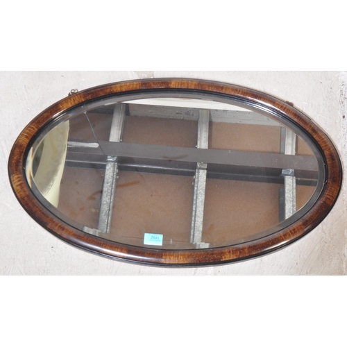 1492 - An early 20th century wall mirror having ovolu faux rosewood cushion frame with  hand painted ebonis... 