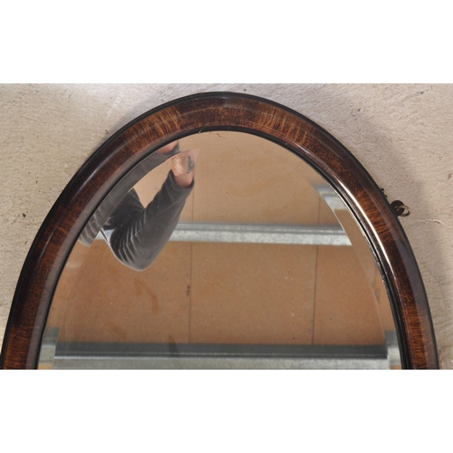 1492 - An early 20th century wall mirror having ovolu faux rosewood cushion frame with  hand painted ebonis... 