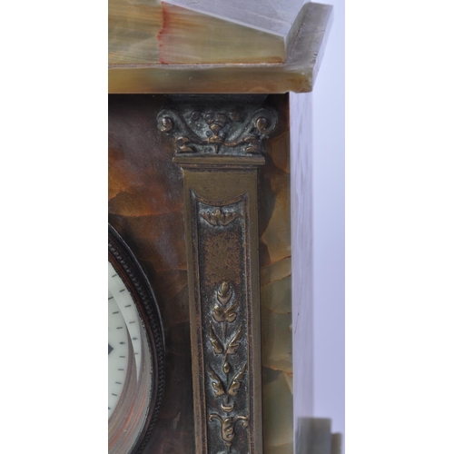 1506 - A 19th century French green and brass onyx mantel striking clock. Of architectural form with an arch... 