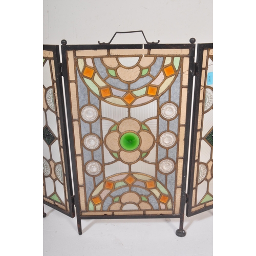 1518 - A 20th century stained and leaded coloured glass triptych fire screen / discretion panel. Metal fram... 