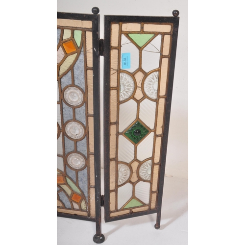 1518 - A 20th century stained and leaded coloured glass triptych fire screen / discretion panel. Metal fram... 