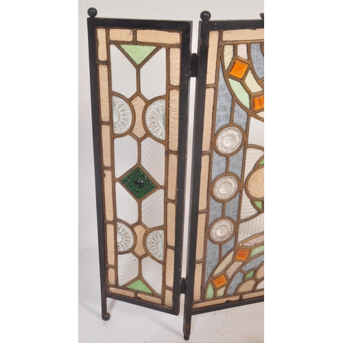 1518 - A 20th century stained and leaded coloured glass triptych fire screen / discretion panel. Metal fram... 