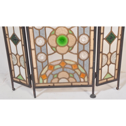 1518 - A 20th century stained and leaded coloured glass triptych fire screen / discretion panel. Metal fram... 