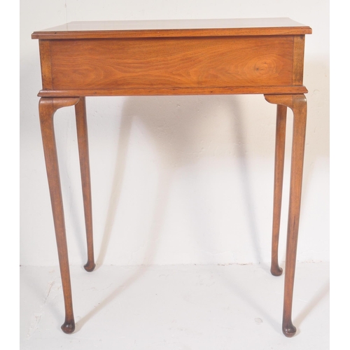 1520 - A 1940's Queen Anne revival mahogany writing table. Raised on cabriole legs with pad feet having fit... 