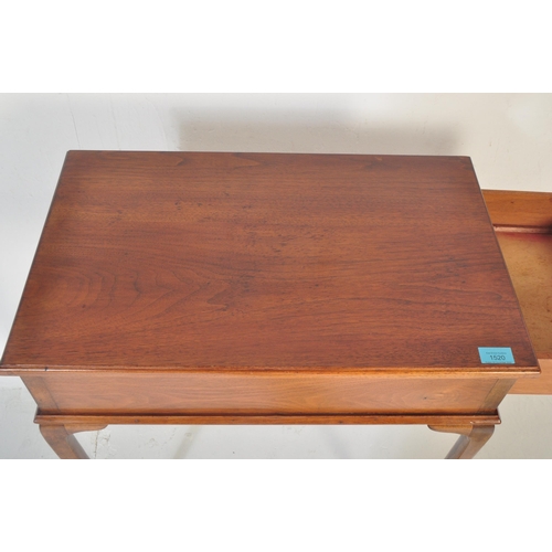 1520 - A 1940's Queen Anne revival mahogany writing table. Raised on cabriole legs with pad feet having fit... 