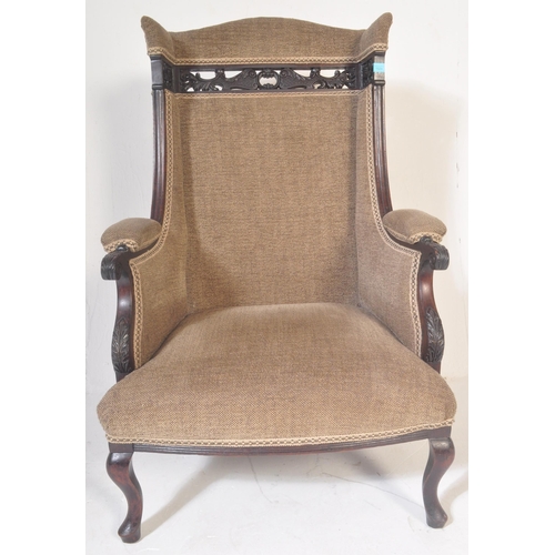 1524 - A Victorian 19th century Aesthetic movement ebonised mahogany upholstered wingback armchair having a... 