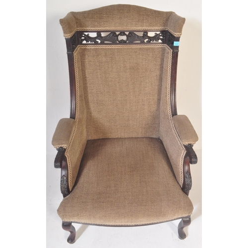 1524 - A Victorian 19th century Aesthetic movement ebonised mahogany upholstered wingback armchair having a... 