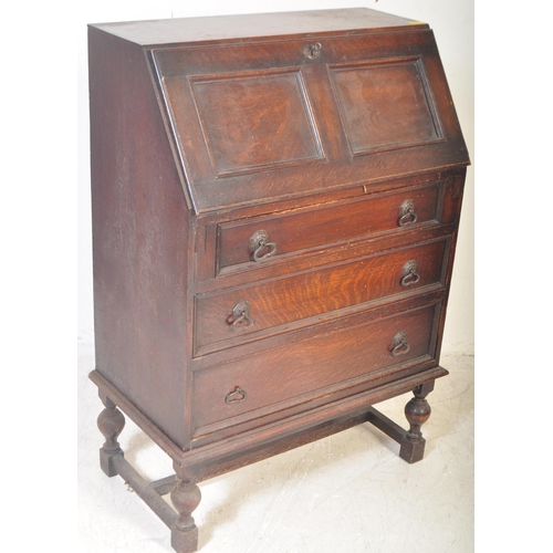 1545 - A vintage 20th Century oak Jacobean revival writing bureau desk. Having a rectangular top, with a sq... 