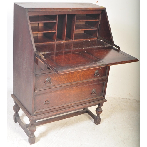 1545 - A vintage 20th Century oak Jacobean revival writing bureau desk. Having a rectangular top, with a sq... 