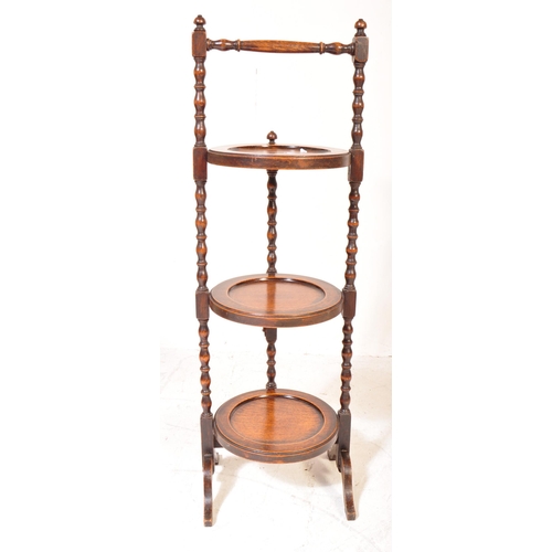 1566 - An Edwardian mahogany folding cake stand  having a handle to top with a circular round cake stands o... 