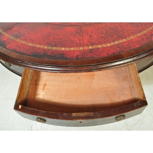 1574 - A late 19th mahogany drum table. With a round circular top, inlaid gilt red leather top with faux dr... 