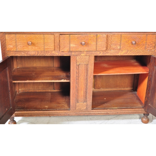 1585 - 1920's solid oak Arts & Crafts - Cotswold School sideboard credenza. Raised on bell feet with a pair... 