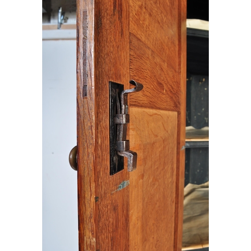 1591 - An 18th century George III country oak double corner cupboard. Raised on bracket feet with twin cupb... 