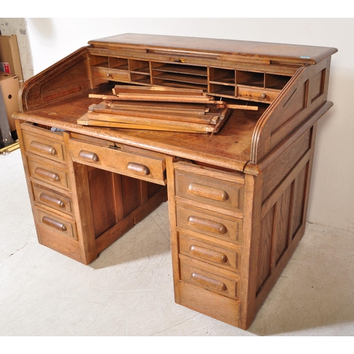 1592 - A 1920’s oak roll top tambour desk having pedestals with drawers to each, pull handles. Atop, a roll... 