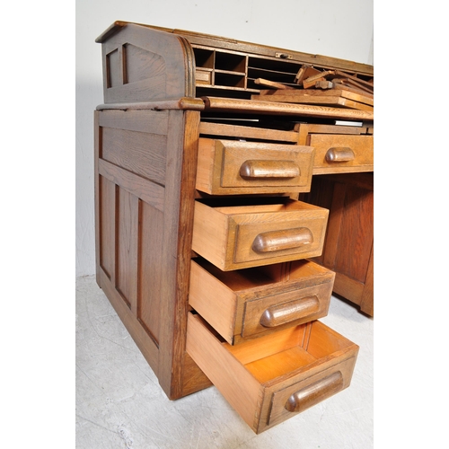 1592 - A 1920’s oak roll top tambour desk having pedestals with drawers to each, pull handles. Atop, a roll... 