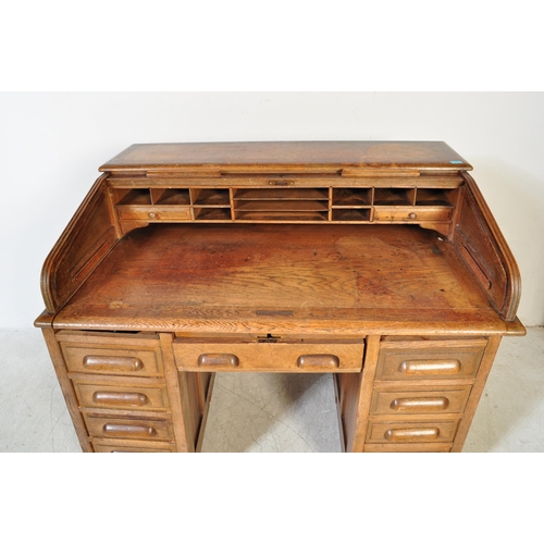 1592 - A 1920’s oak roll top tambour desk having pedestals with drawers to each, pull handles. Atop, a roll... 