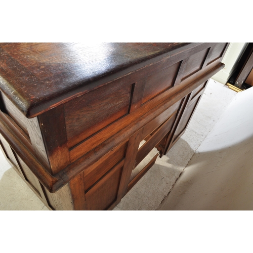 1592 - A 1920’s oak roll top tambour desk having pedestals with drawers to each, pull handles. Atop, a roll... 