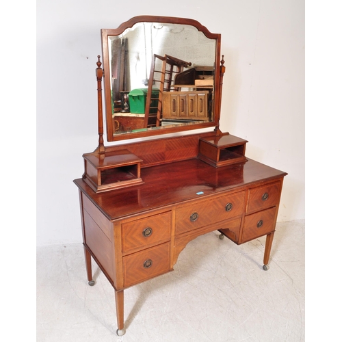 1593 - Edwardian mahogany dressing table chest. Raised on squared legs with series of drawers flanking knee... 