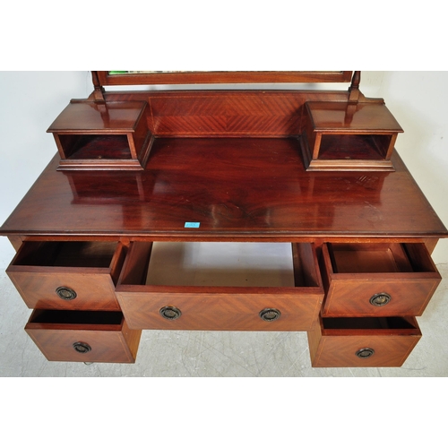 1593 - Edwardian mahogany dressing table chest. Raised on squared legs with series of drawers flanking knee... 