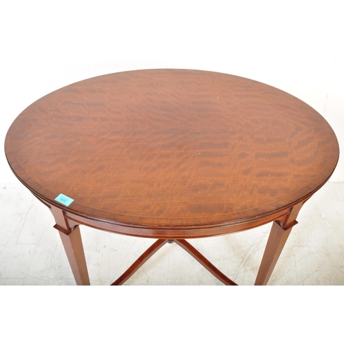 1602 - An  Edwardian mahogany and line inlaid oval occasional table. Raised on squared legs with angled fee... 