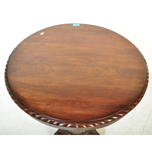 1608 - A 19th Century mahogany and cast iron tilt top pedestal wine table. The mahogany table top of circul... 