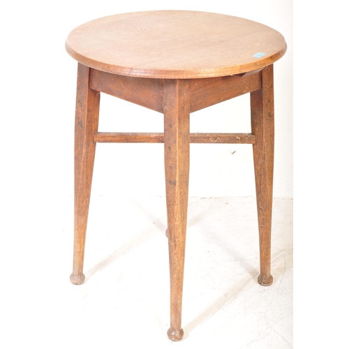 1610 - A 1920’s Arts & Crafts oak tavern pub table. Circular top over square tapering legs with stretchers ... 