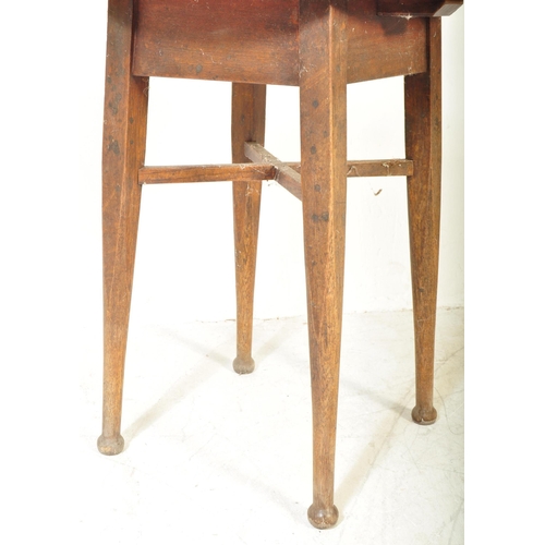 1610 - A 1920’s Arts & Crafts oak tavern pub table. Circular top over square tapering legs with stretchers ... 