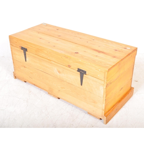 1618 - A vintage 20th Century pine trunk. The trunk of rectangular form with a slatted pine hinged top over... 