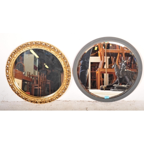 1619 - Two vintage 20th Century round wall mirrors. The lot to include one moulded mirror with moulded gilt... 