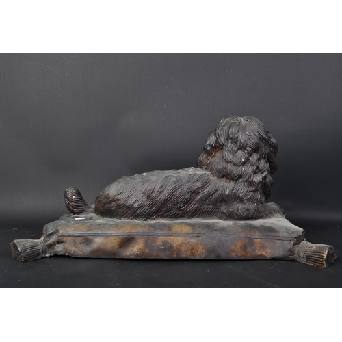 1621 - A vintage 20th Century bronze dog on pillow. The Spaniel dog in lying down position on a pillow / cu... 