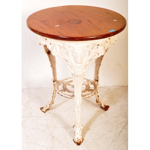 1623 - A 19th Century oak top cast iron pub bistro table. Of circular form with an oak top, cast iron white... 