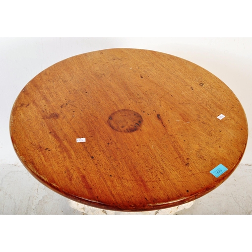 1623 - A 19th Century oak top cast iron pub bistro table. Of circular form with an oak top, cast iron white... 