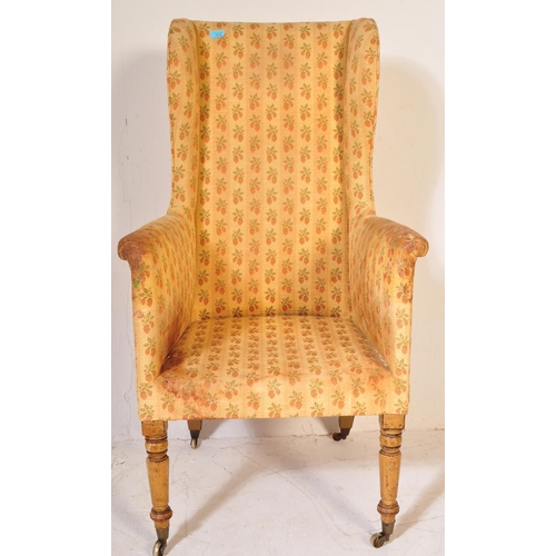 1627 - 19th Century Victorian mahogany wingback armchair. The chair with turned legs and castors having ove... 