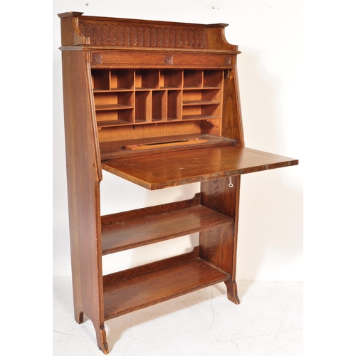 1628 - 1920's oak Arts & Crafts student bureau desk. The upright body with a series of shelves under fall f... 