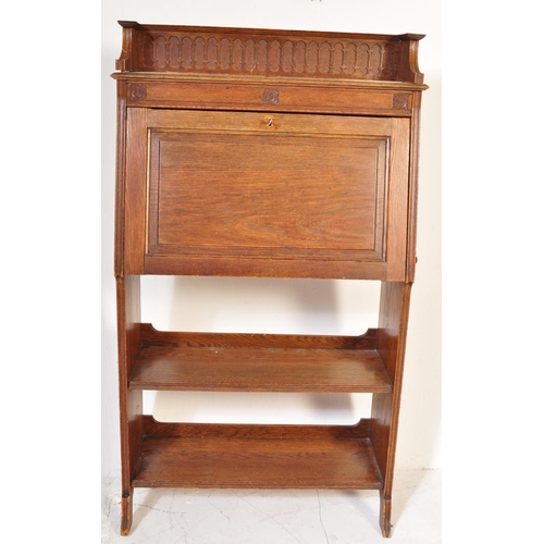 1628 - 1920's oak Arts & Crafts student bureau desk. The upright body with a series of shelves under fall f... 