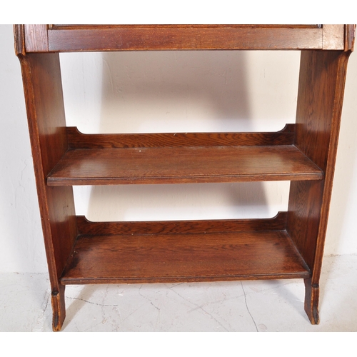 1628 - 1920's oak Arts & Crafts student bureau desk. The upright body with a series of shelves under fall f... 