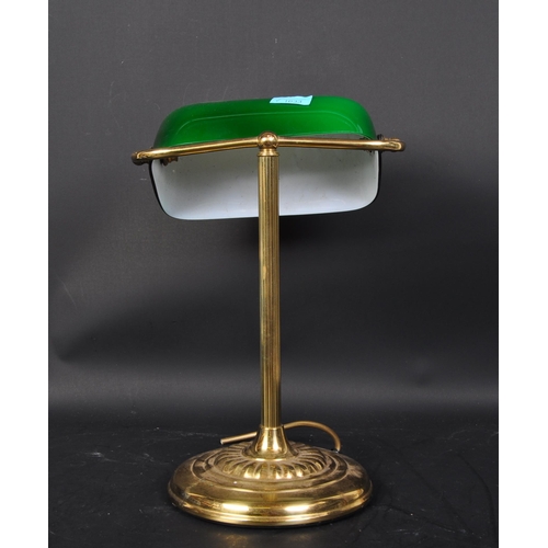 1633 - A vintage 20th Century bankers office table lamp light. Having a green glass swinging shade, with br... 