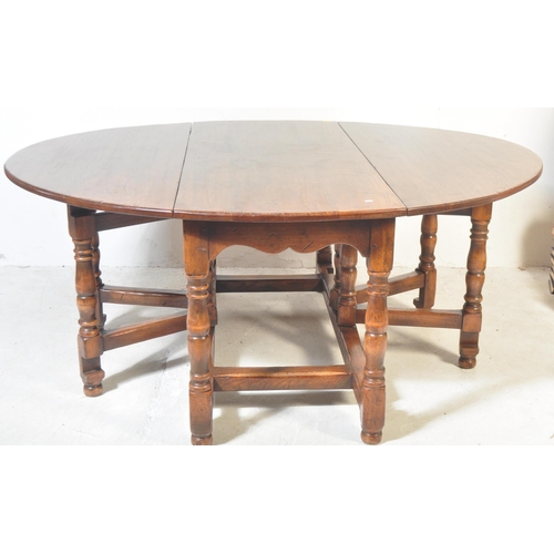 1657 - A Brights of Nettlebed 18th Century style oak oval drop leaf dining table and set of leather dining ... 