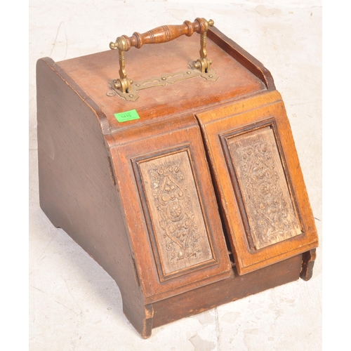 1662 - A Victorian 19th century oak & brass purdonium coal scuttle having a brass handle over twin hinged f... 